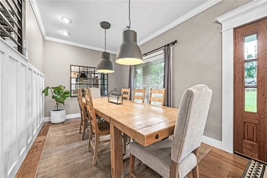 Modern farmhouse dining room features statement pe