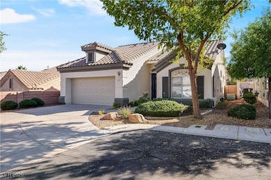 Mediterranean / spanish house featuring stucco siding, concrete driveway, an attached garage, and a tile roof