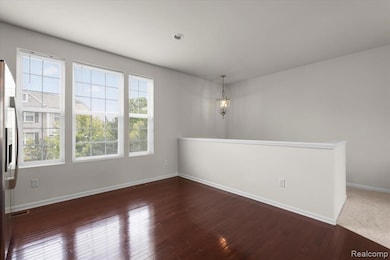 Spare room featuring dark wood-type flooring
