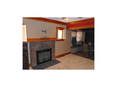 Living Room. Warm colors and original woodwork hig