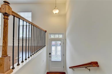 Foyer with a high ceiling and wood-type flooring