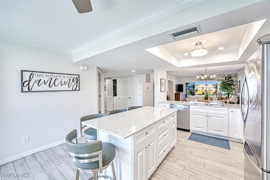 Kitchen featuring a kitchen breakfast bar, white c
