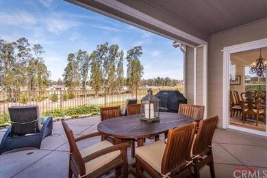 Covered patio and professional landscaping gives y