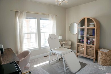 Office with carpet floors and a chandelier