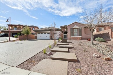 View of front facade with a garage, driveway, a ti