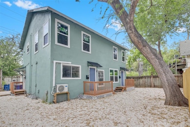 Back of property featuring a deck, a fenced backyard, and stucco siding
