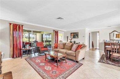 Living room with crown molding and lanai access
