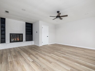 Unfurnished living room with a ceiling fan, baseb