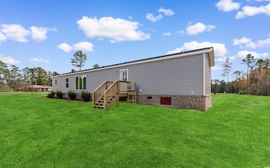 Rear view of house featuring a yard