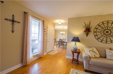 The entry way opens to a hallway, dining room and living room.