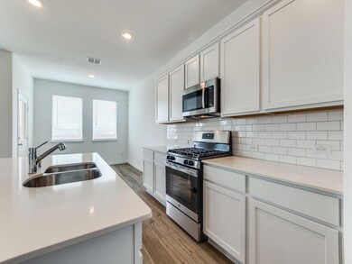 Quartz counter tops, gas stove, venting microwave.