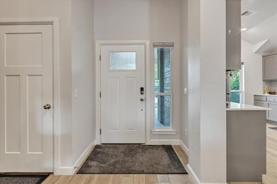 Entryway with wood finished floors and baseboards