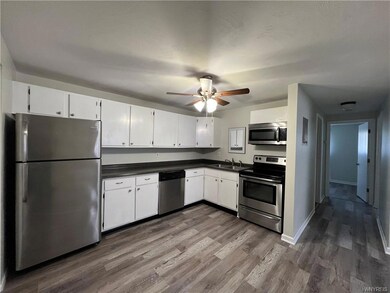 white kitchen w stainless steel appliances