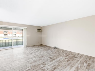 Spare room featuring light wood finished floors and a wall mounted AC