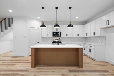 Kitchen with light countertops, light wood-type fl
