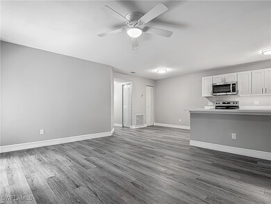 Unfurnished living room with dark wood-style floor