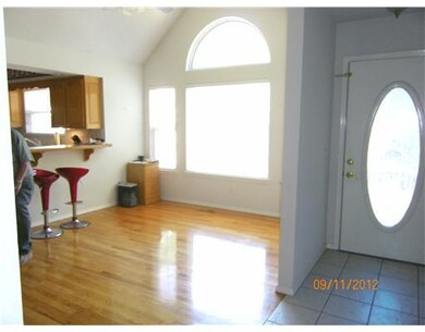 Dining Room. Dining room adjoins kitchen passthrough.  Hardwood floor.  Tiled entry.