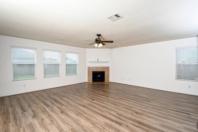 This view of the gas fireplace is from the kitchen and dining area.