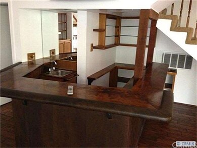 wet bar with flat screen TV above