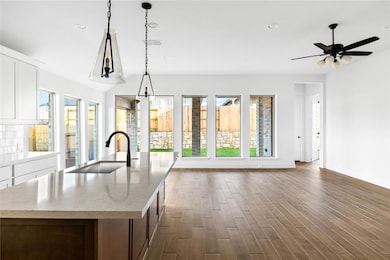 Kitchen with a sink, healthy amount of natural li