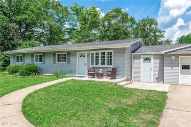 Ranch-style home featuring a front lawn and a shingled roof