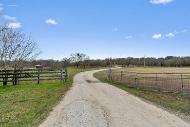 View of street with dirt driveway and a rural view