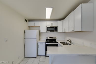 Kitchen featuring stainless steel appliances, a si