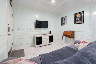 Living area with light tile patterned flooring, a