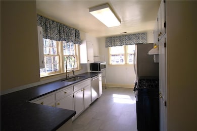 Kitchen featuring white cabinets, stainless steel 