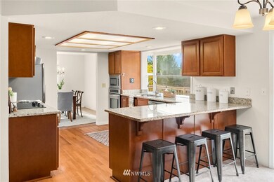 The kitchen was refreshed ~5 years ago. Notice the eating bar, stainless appliances and hard surface countertops.