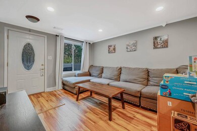 Living area with light wood finished floors, recessed lighting, and ornamental molding