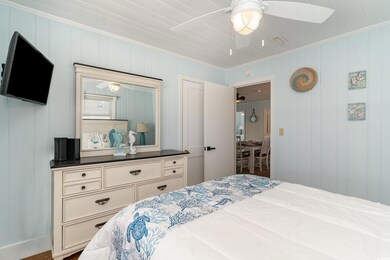 Bedroom with ceiling fan and crown molding