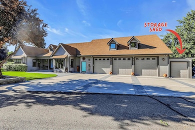 View of front of property featuring driveway and roof with shingles