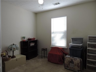 Living area with a ceiling fan, vaulted ceiling, a