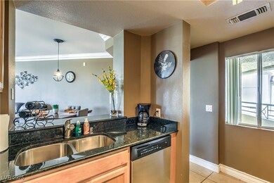 Kitchen with stainless steel dishwasher, light til