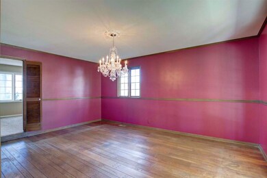 The formal dining room has wood flooring.