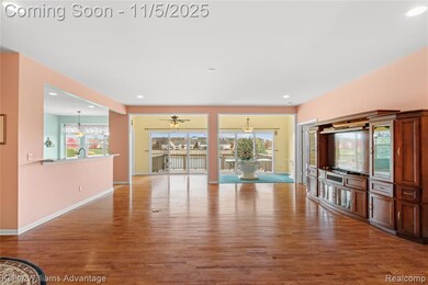 Unfurnished living room with healthy amount of natural light, recessed lighting, light wood finished floors, a chandelier, and a ceiling fan