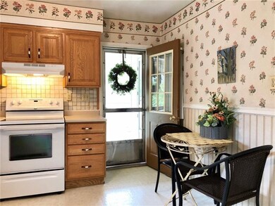Main entry from porch into a bright kitchen.