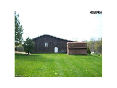 Side view of detached garage and shed