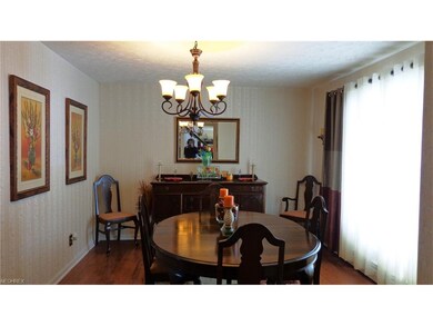 Formal dining room with newer chandelier and hardw