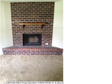 Fireplace in den with brick hearth