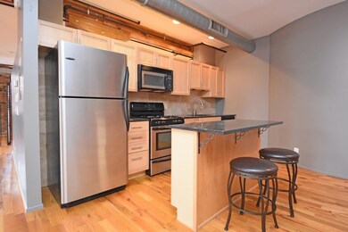 The condo's kitchen features granite counters, sta