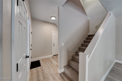 Foyer with wood finished floors and stairway