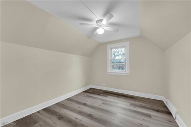 Bonus room with light hardwood / wood-style floors, ceiling fan, and lofted ceiling