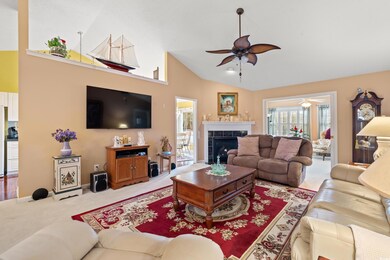 Living room with ceiling fan, high vaulted ceiling