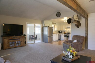 View from living room to sun porch and kitchen.
