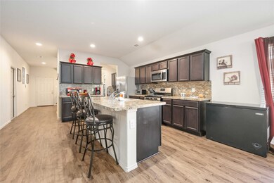 Kitchen with large island, plenty of cabinet and counter space.