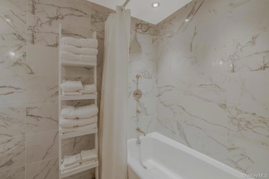 Bathroom with shower / bath combination with curtain