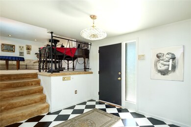 The stairs lead from the entry level to the main level living room