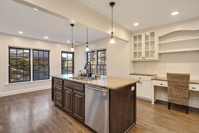 Kitchen featuring dark brown cabinetry, a sink, op